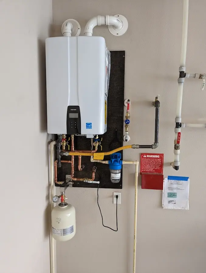 Professional plumber installing copper piping in a Garden Acres home